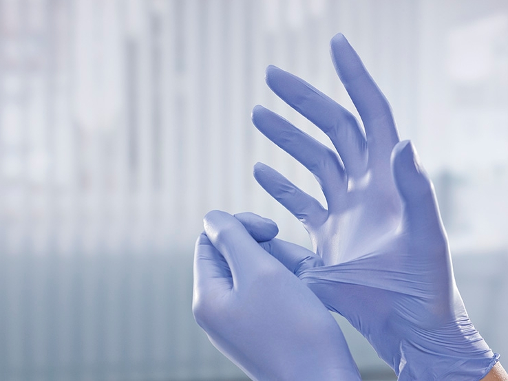 Hands in blue examination gloves