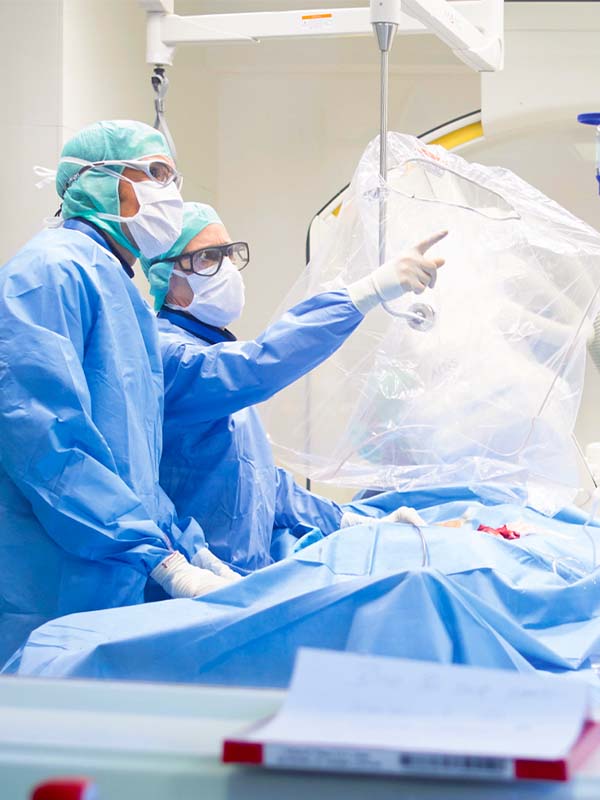 Two surgeons discuss the findings in the catheter lab