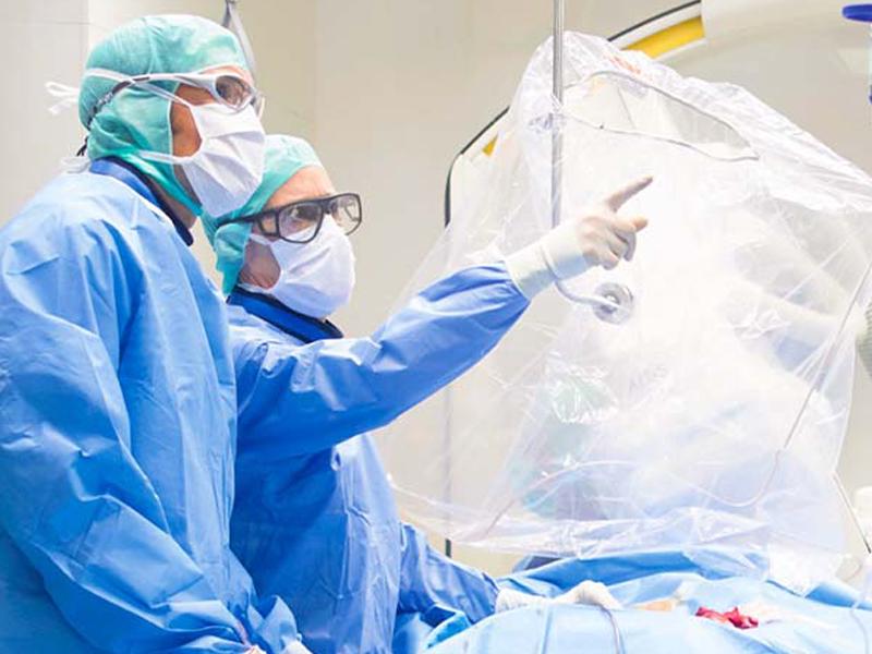 Two surgeons discuss the findings in the catheter lab