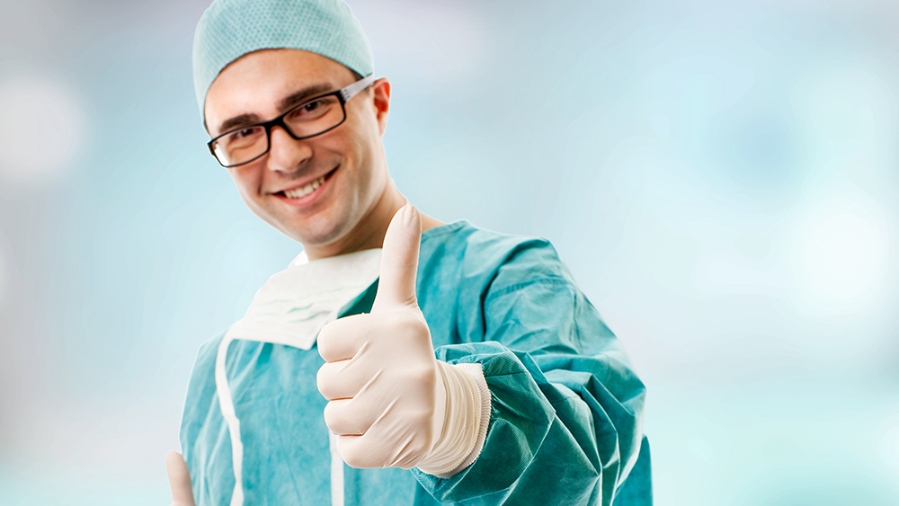 Young surgeon with his thumb up
