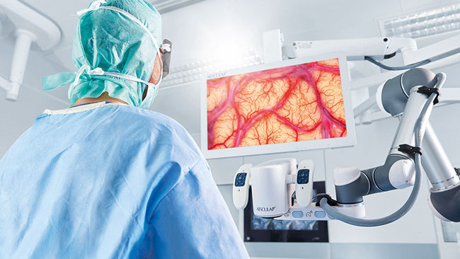 Surgeon in the OR with Aesculap Aeos® digital surgical microscope platform