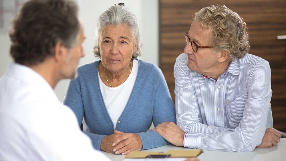 dialysis-patient-elderly-woman-with-husband-sitting-in-front-of-professional-consultation-landscape