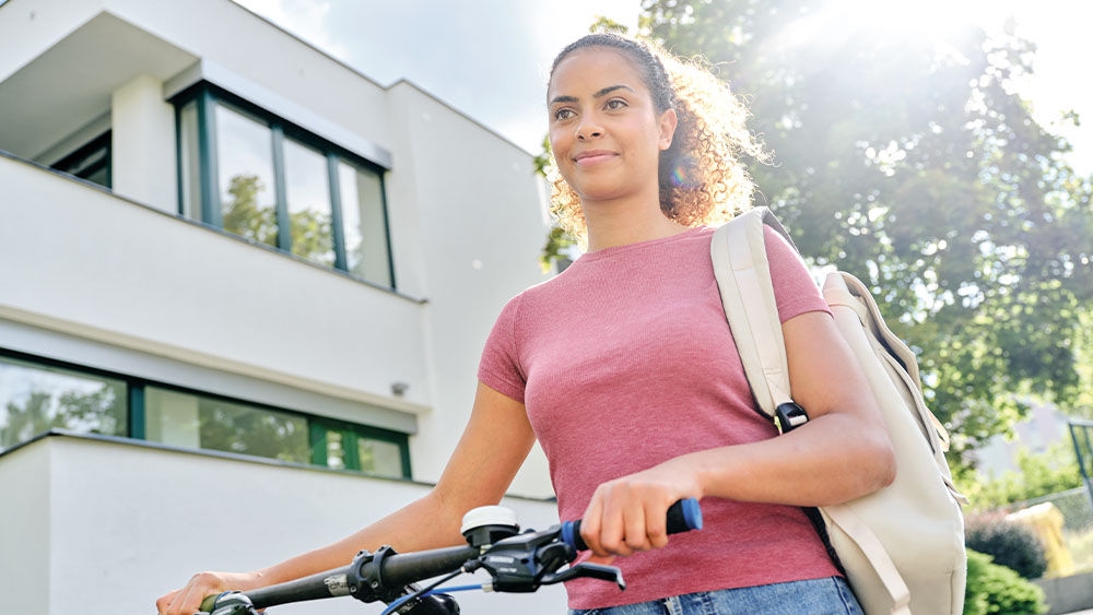 dialysis-nurse-in-casual-clothes-pushing-bike-outside-dialysis-center.jpg