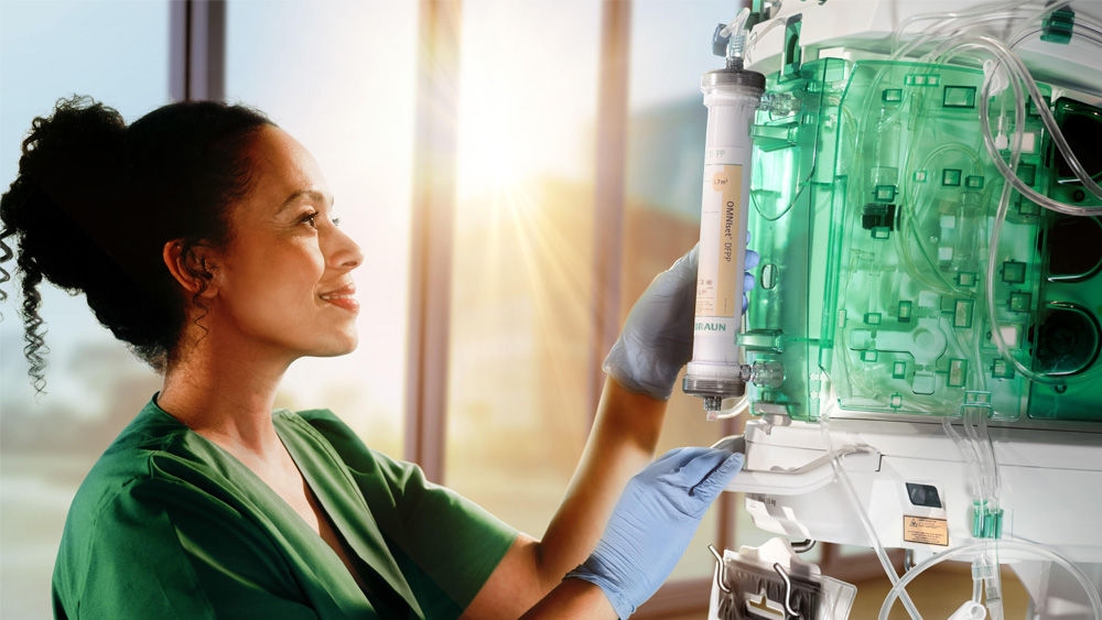 Nurse inspecting the filter of the OMNI plus machine.