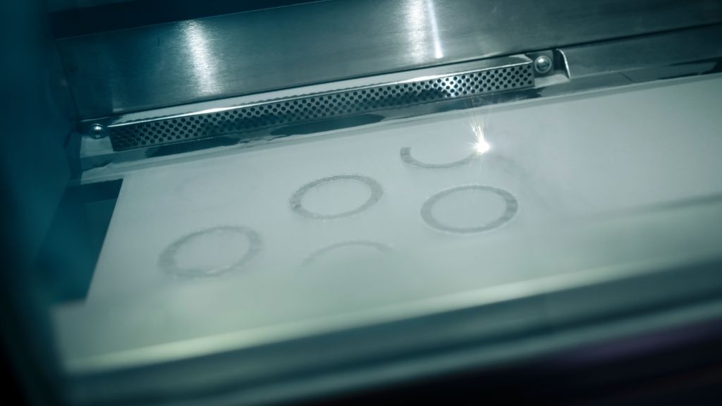 In selective laser sintering, a fine layer of titanium powder is applied to a working plate and melted at pre-programmed points using a laser. Layer by layer, almost any three-dimensional shape can be created.