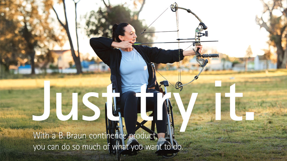A person in a wheelchair practicing archery outdoors, aiming a compound bow with trees and grass in the background. The text on the image reads: "Just try it. With a B. Braun continence product, you can do so much of what you want to."