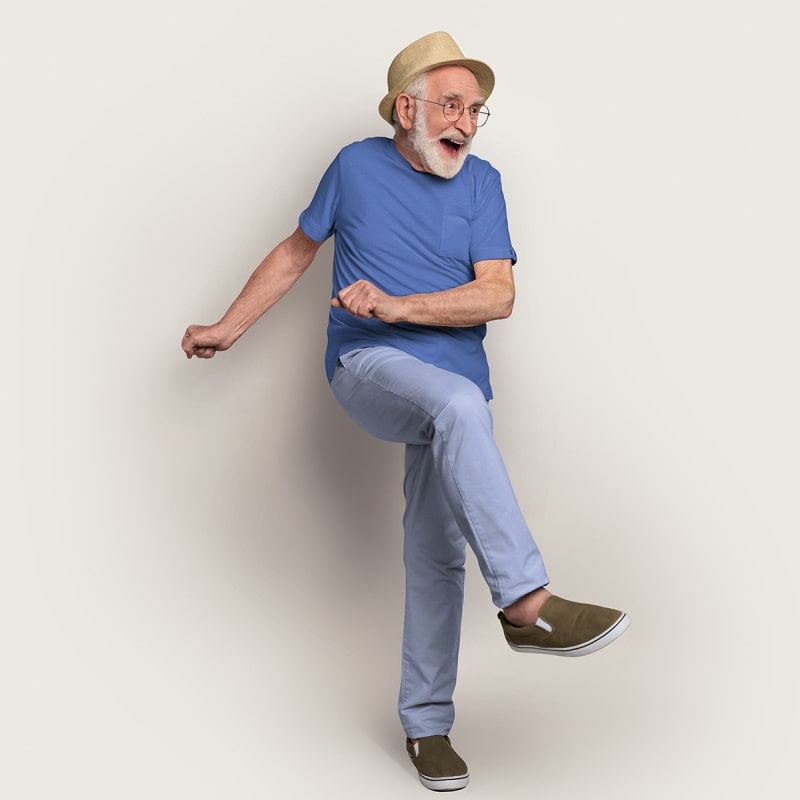 Elderly man with hat and blue shirt does a kick