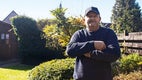 Ralf standing in his garden with arms crossed looking to the camera