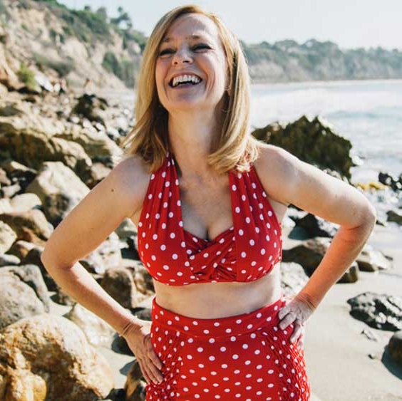 woman at the beach, laughin in red bikini with white dots