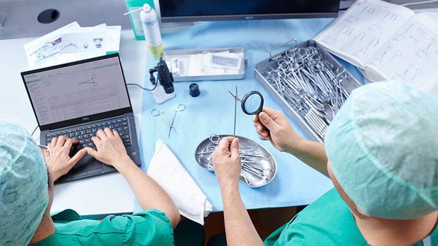 CSSD employees managing surgical instruments in the CSSD