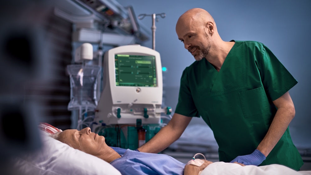 Healthcare professional supporting a patient receiving acute dialysis therapy with the OMNI platform in the ICU