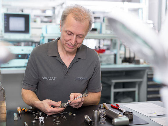 Male employee of the Aesculap Technical Service controlles his tools