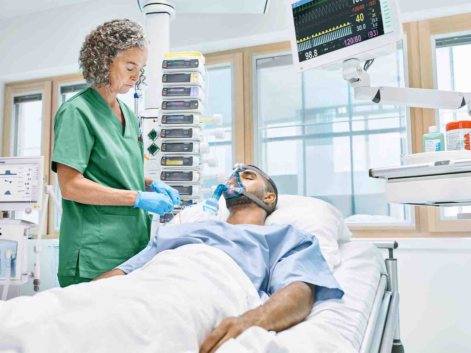 Critical care scene showing a patient with sepsis receiving monitored treatment in a modern clinical environment, supported by advanced medical equipment and attentive health care professionals.