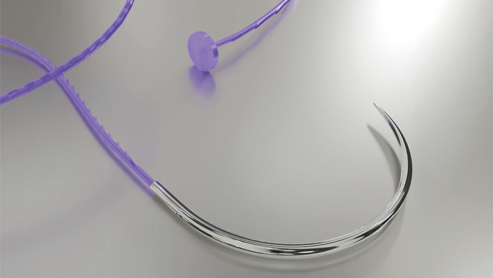 A violet barbed suture with an anchor at the end and rounded needle on a grey background