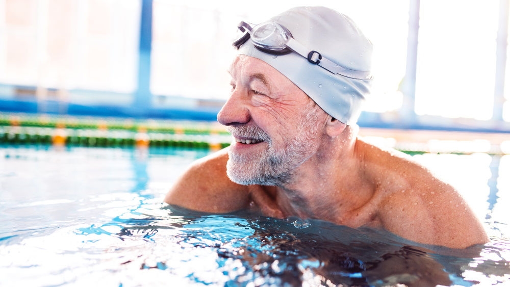 Elderly man in swimming pool: I am proud of myself for taking this step. Swimming is such a great feeling and possible with a stoma.