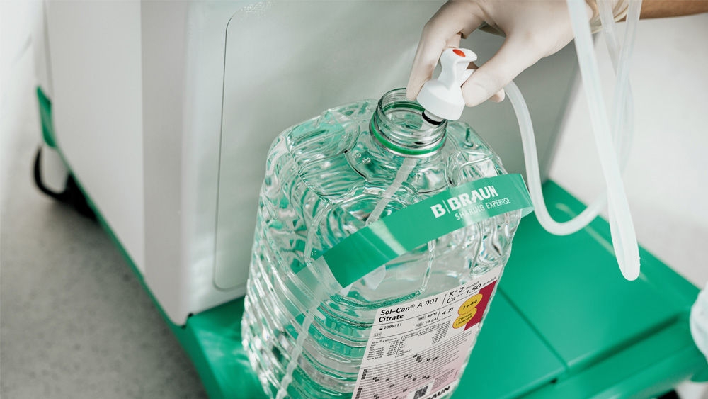 Hand of a medical worker holding a small tube in the sol-can canister to get the liquid from inside