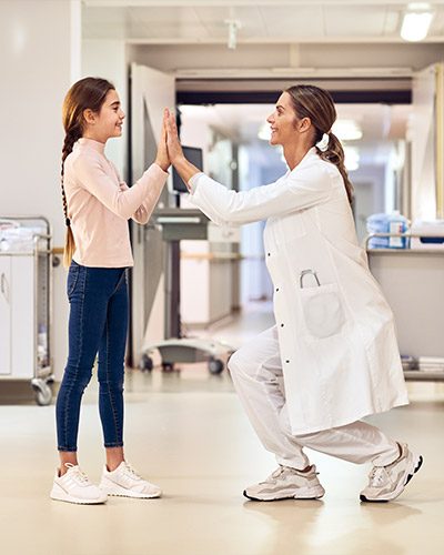 doctor and patient girl on the pediatrics hospital floor