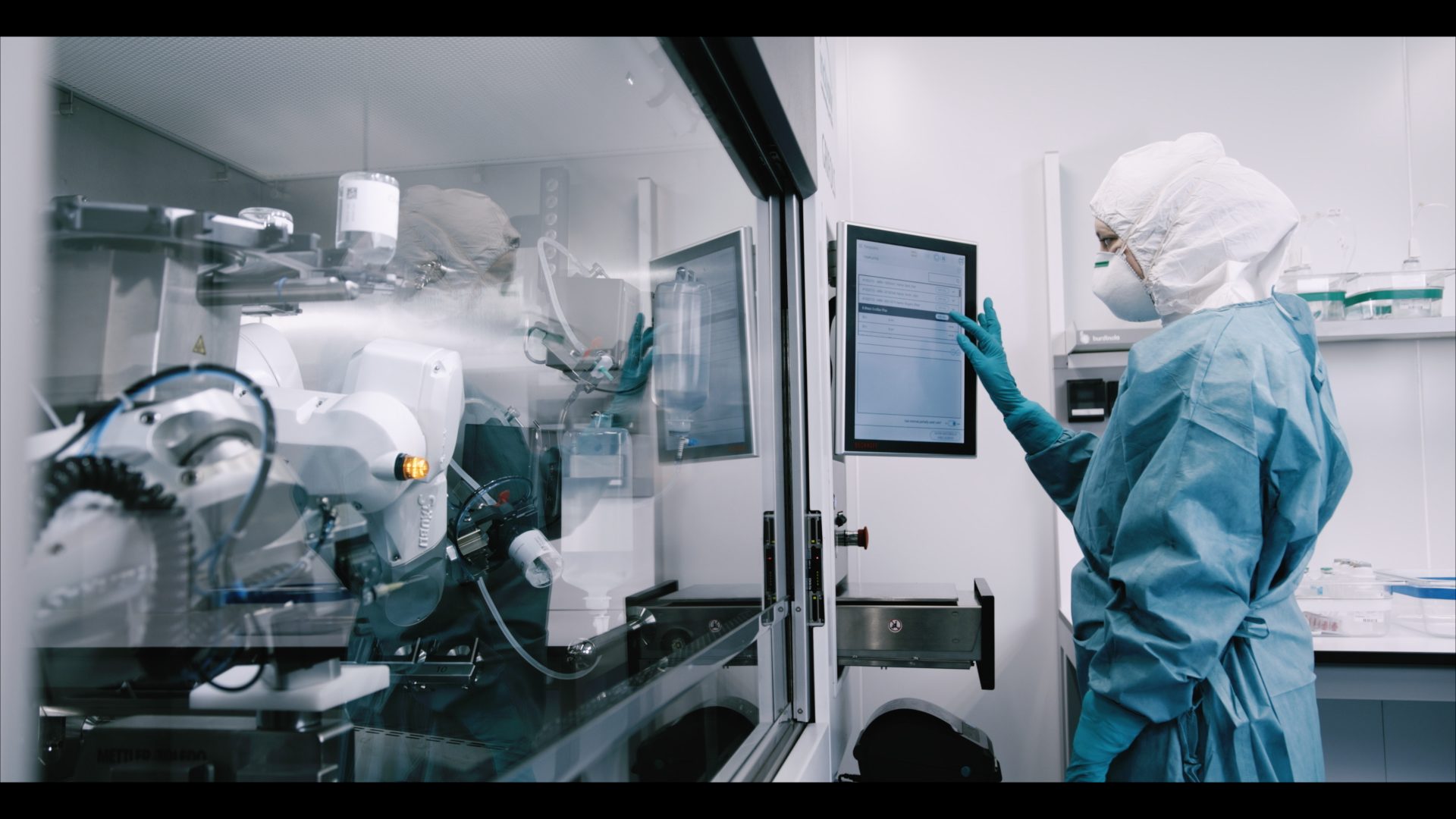 Pharmacist preparing drugs with automated compounding robot