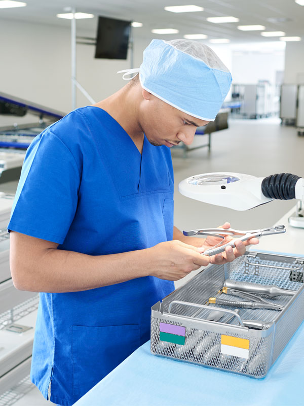 CSSD employee checks different instruments in a basket