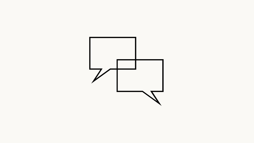 The image displays two overlapping speech bubbles, one slightly behind the other, representing communication or dialogue between people.