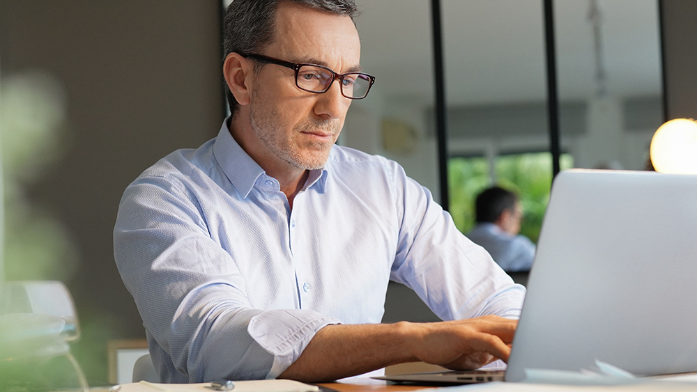 Man typing concentrated on a laptop