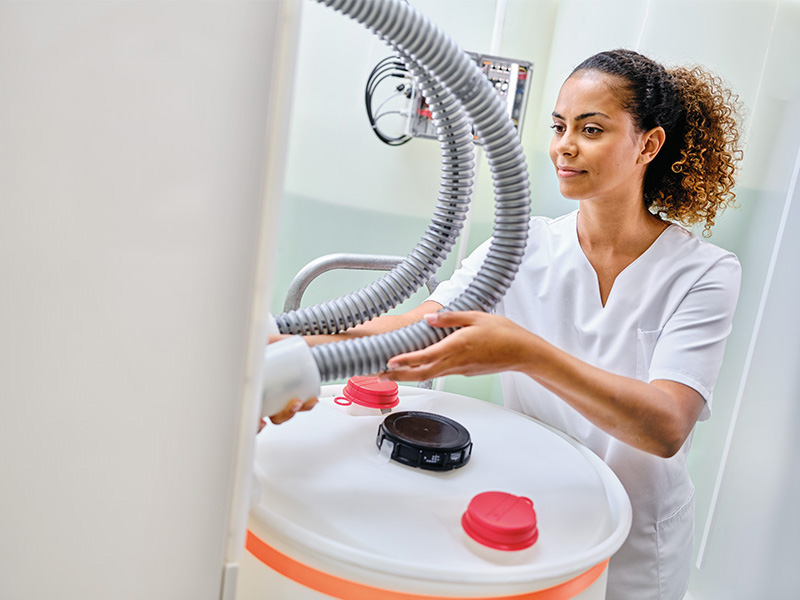 Dialyis nurse connecting flexible tubings to ECOCart concentrate cartridge.
