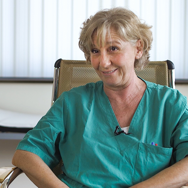 Female nephrologist sitting in a chair smiling