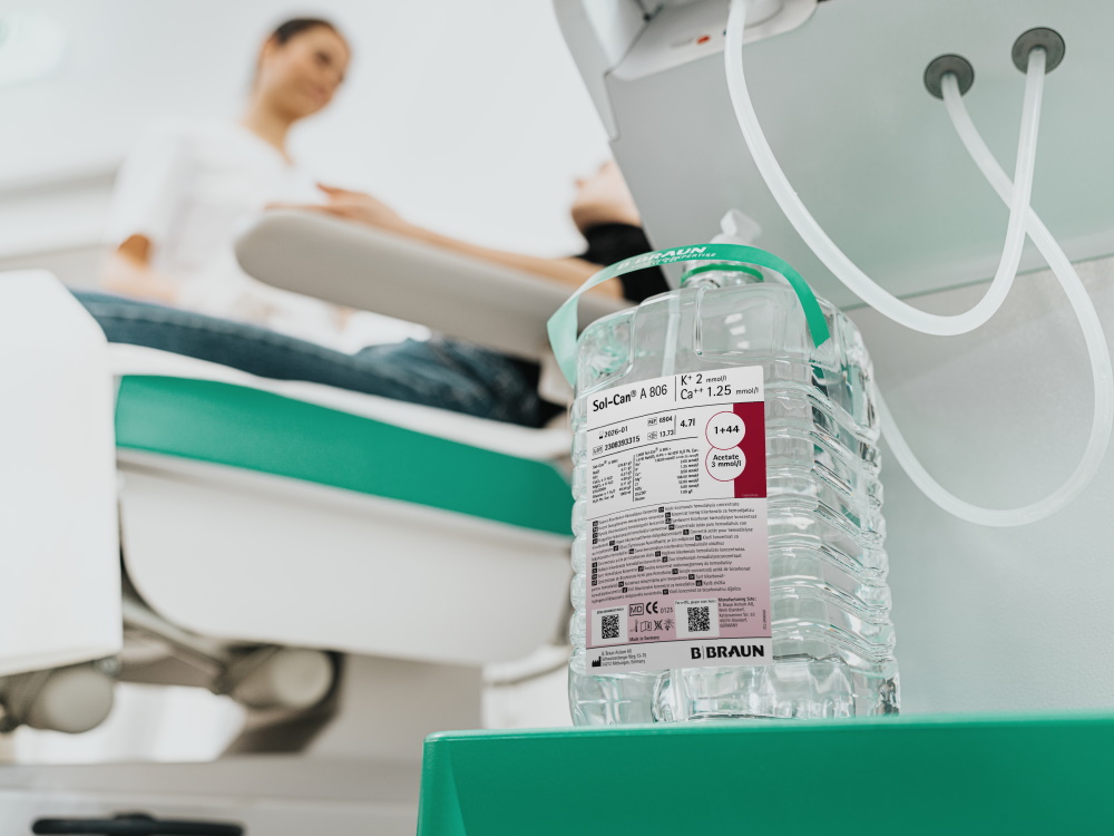A large bottle of Sol-Can. In the background doctor talking to the patient