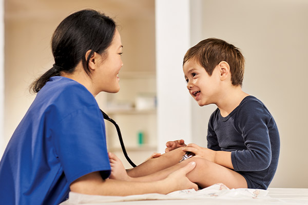 Pediatric doctor is talking with patient boy