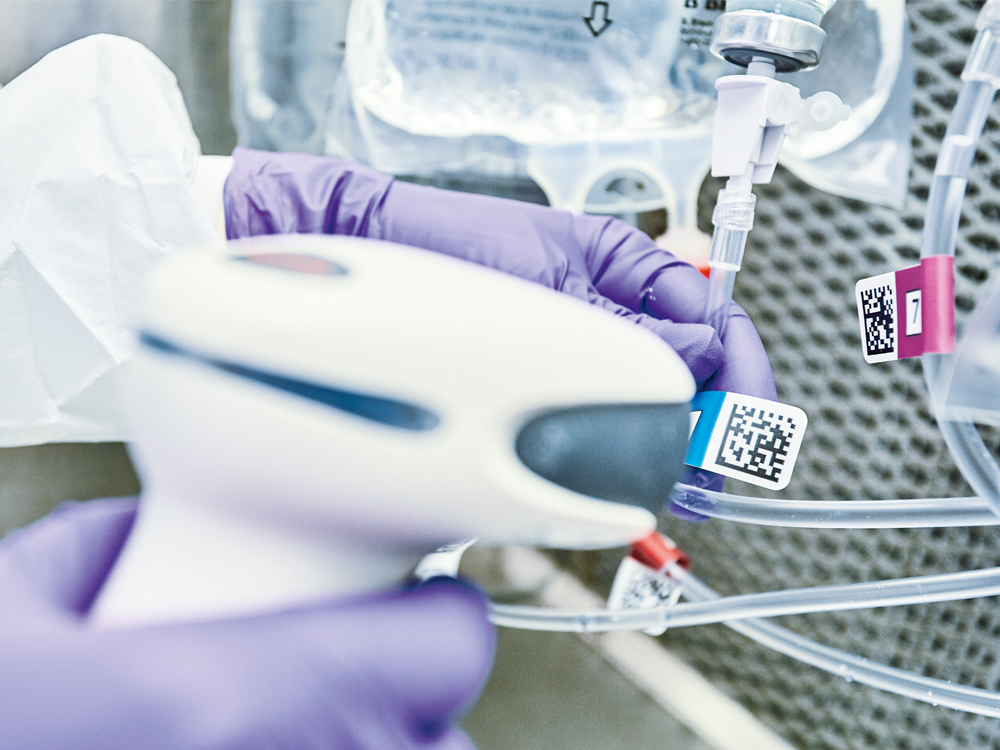 Hands of a medical worker scanning a QR code