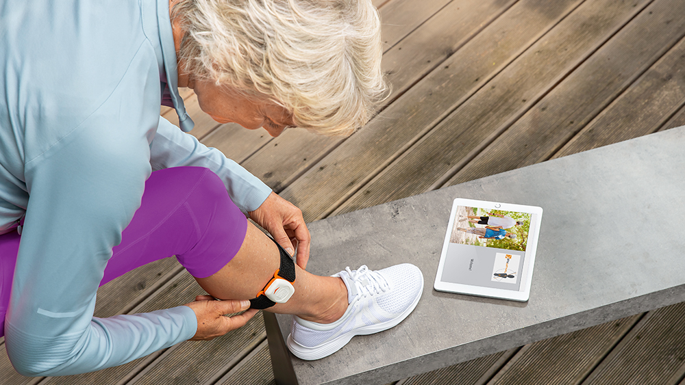 Female patient put on the rehabilitation sensor on their calf