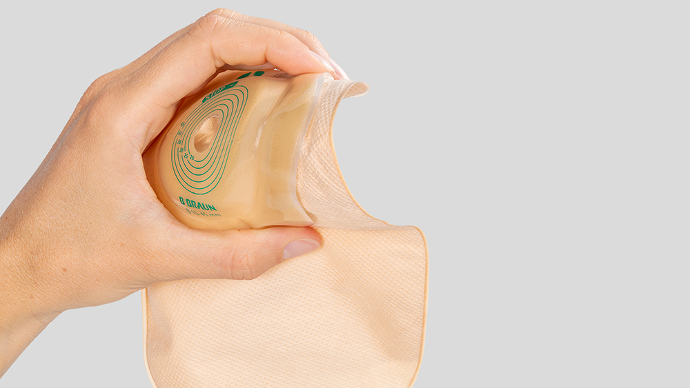 Hand holding a stoma bag