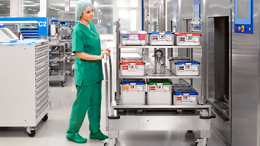 CSSD employee pushes a trolley with sterile containers