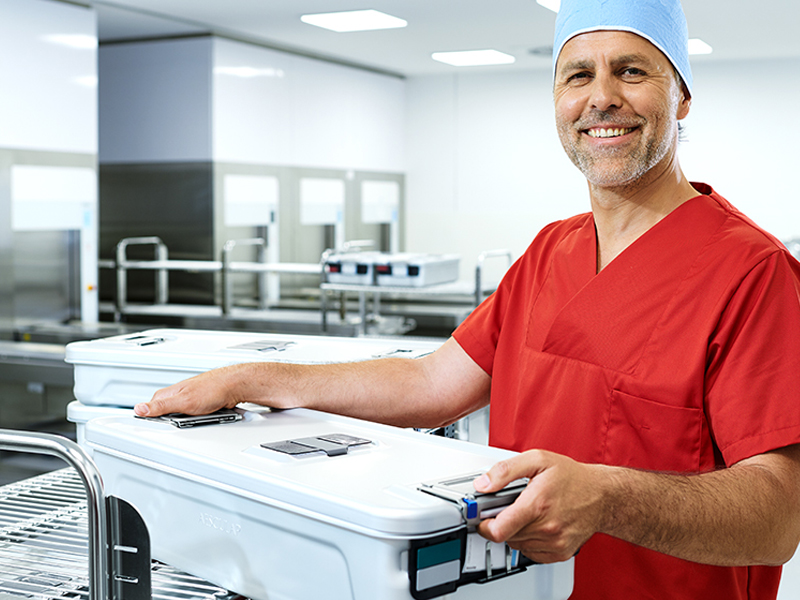 CSSD employee with a sterile container in his hands