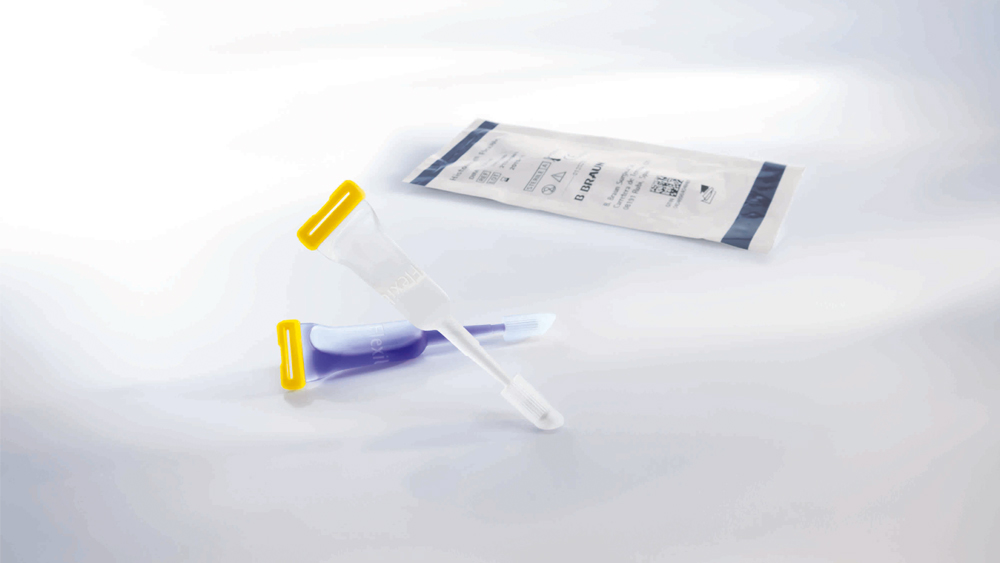 Two skin closure adhesive tubes with blue skin adhesive on a grey ground, behind you can see a peel off blister package of the skin adhesive.