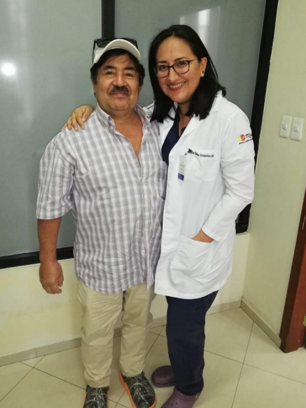 Mr Gallo and his doctor close together, smiling happily