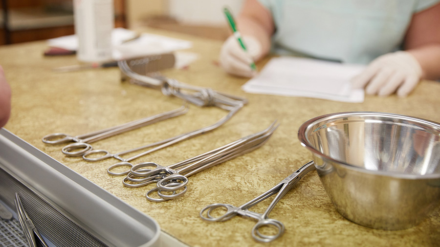 CSSD employee managing surgical instruments in the CSSD